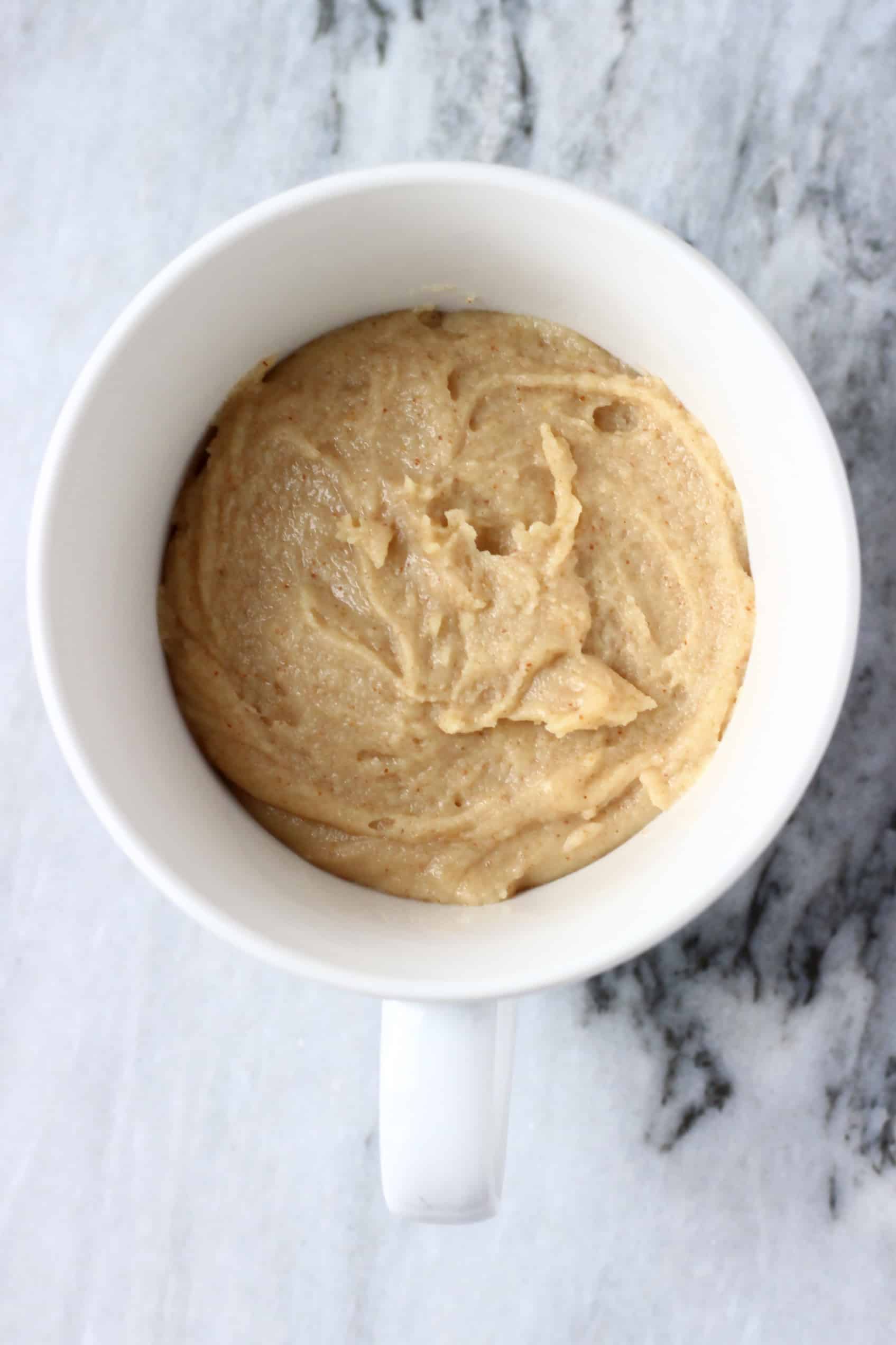 Raw Vegan Biscoff Mug Cake batter in a white mug