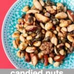Photo of caramelised nuts on a green plate against a red background