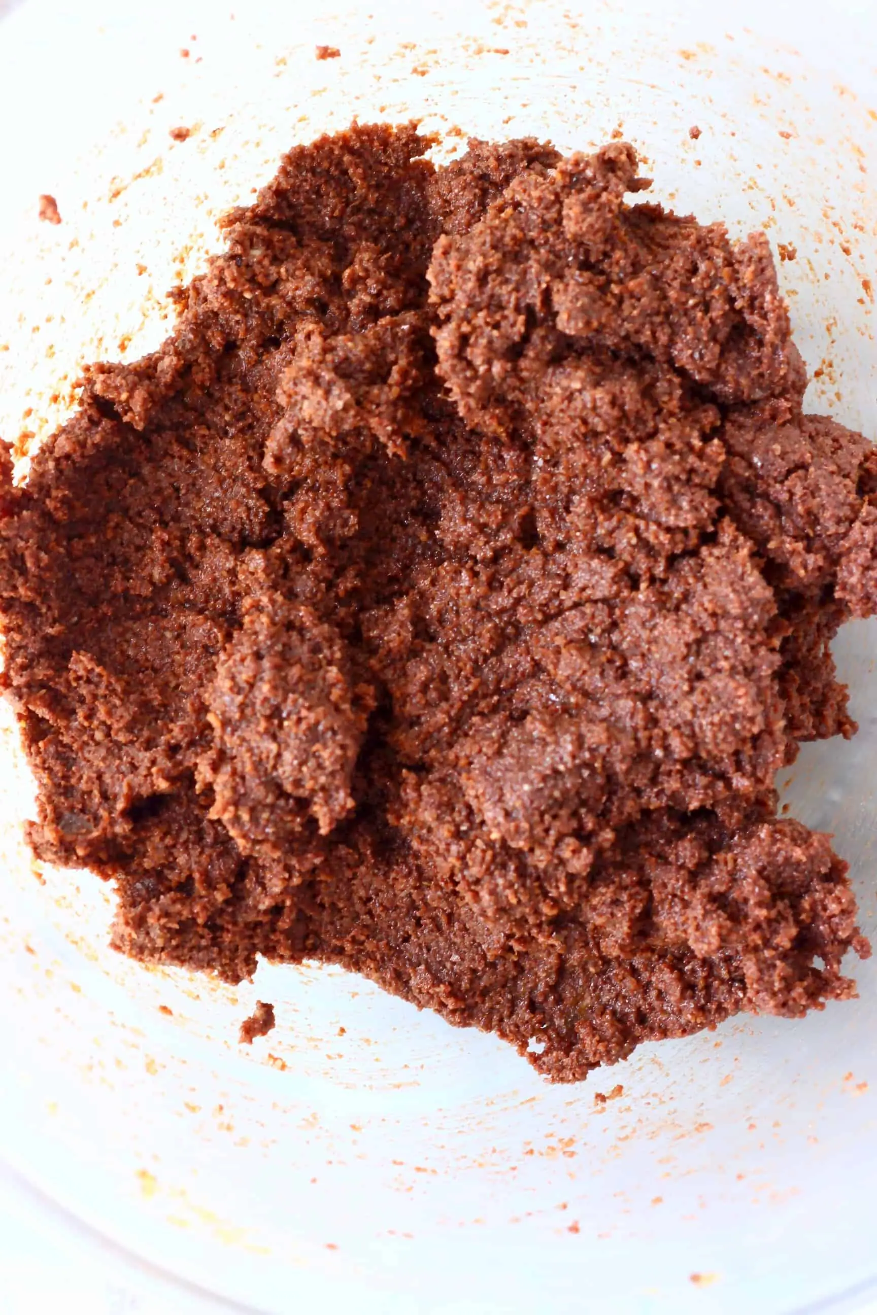 Raw gluten-free vegan chocolate torte batter in a glass mixing bowl