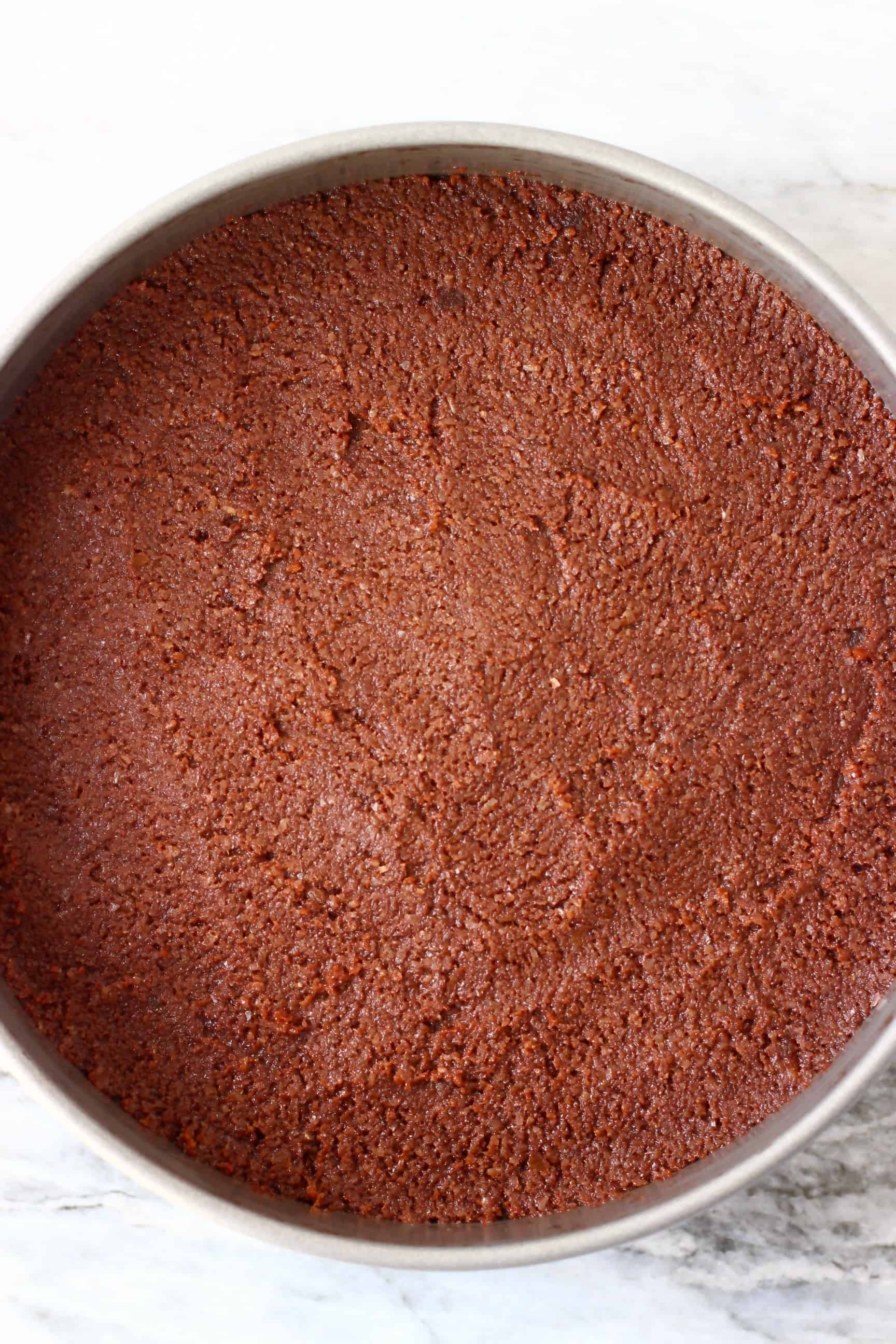 Raw gluten-free vegan chocolate torte batter in a springform baking tin 