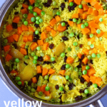 Photo of yellow rice with vegetables in a large saucepan against a grey background