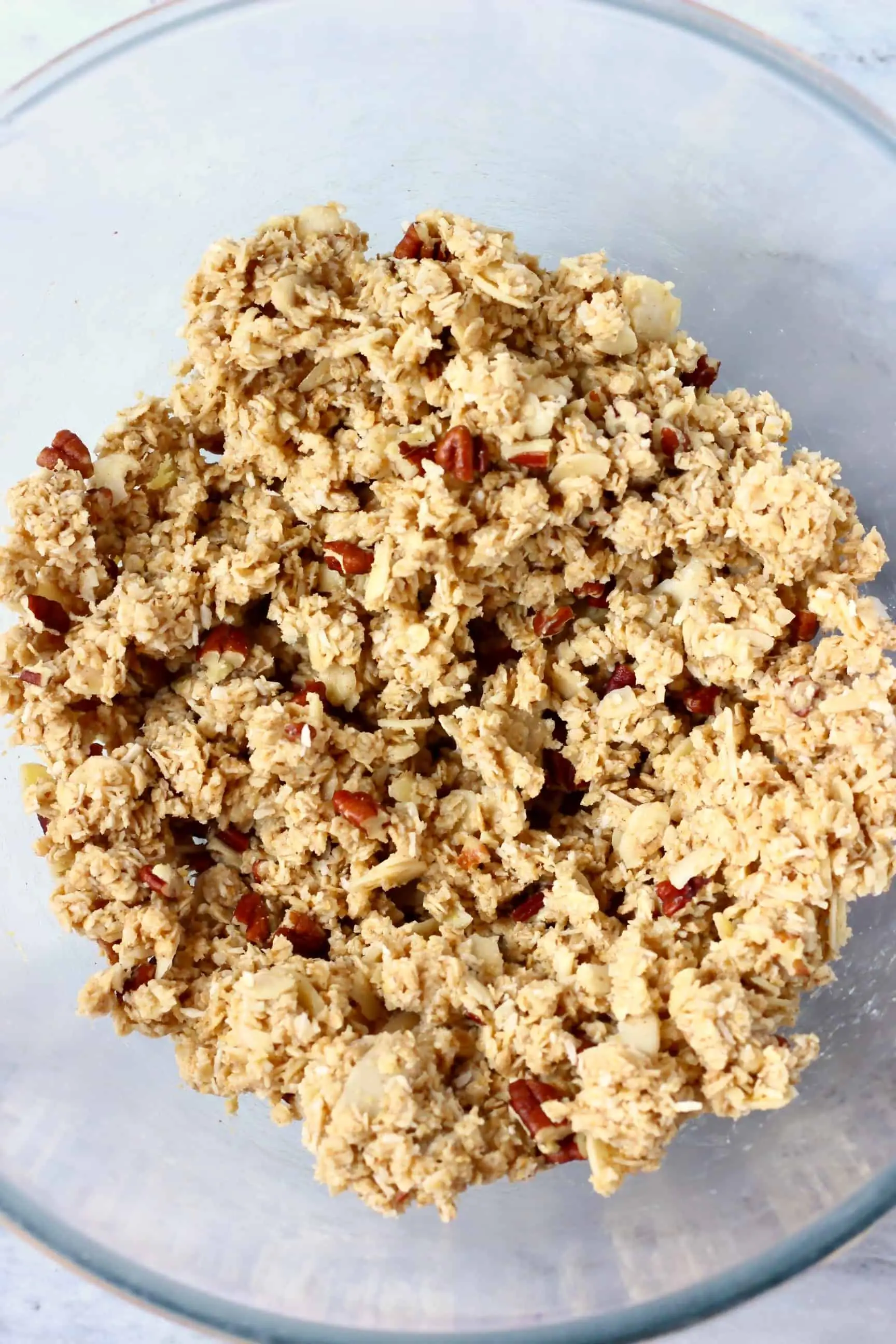 Raw vegan granola bar mixture with chopped oats in a bowl