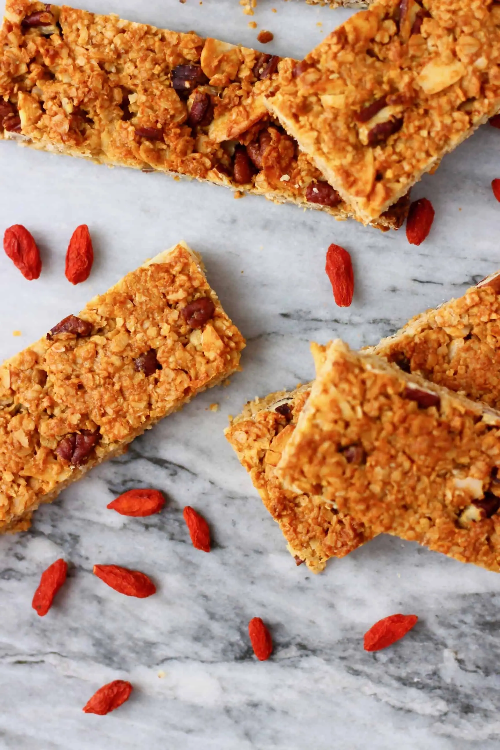 Five vegan granola bars on a marble background