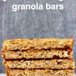 A stack of five granola bars on a marble slab against a grey background