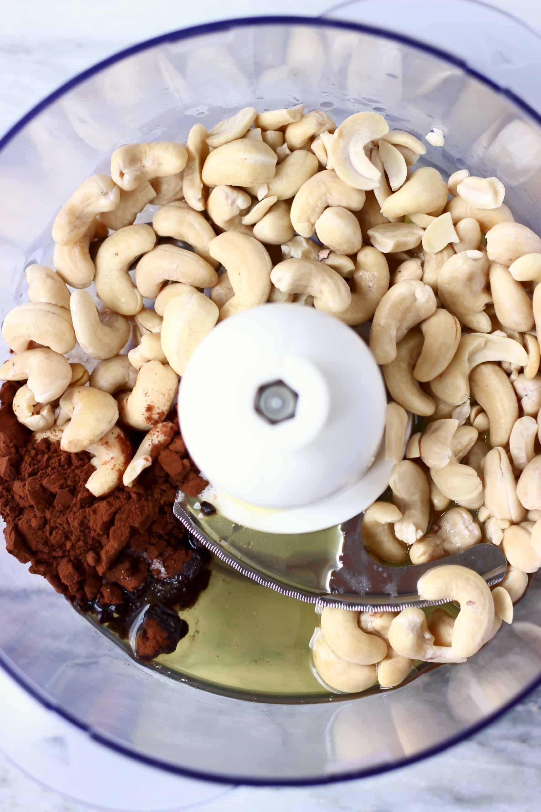 These Vegan Cashew Chocolate Truffles are the most delicious treat - they're melt-in-your-mouth silky, super creamy, and unbelievably healthy! Also gluten-free, paleo and refined sugar free. #rhiansrecipes #chocolate #vegan #glutenfree #dairyfree #paleo Cashew nuts, cocoa powder, agave syrup and melted cacao butter in a food processor