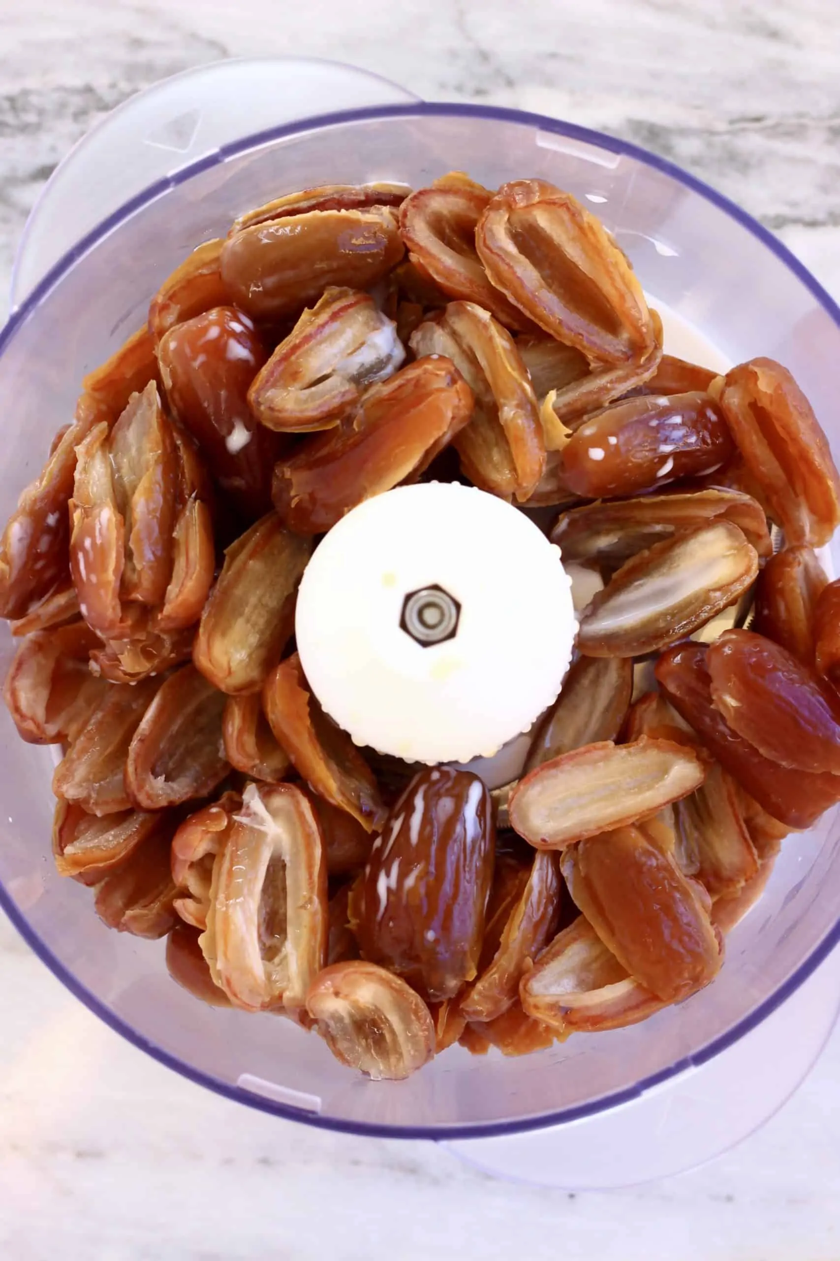 Dates and almond milk in a food processor