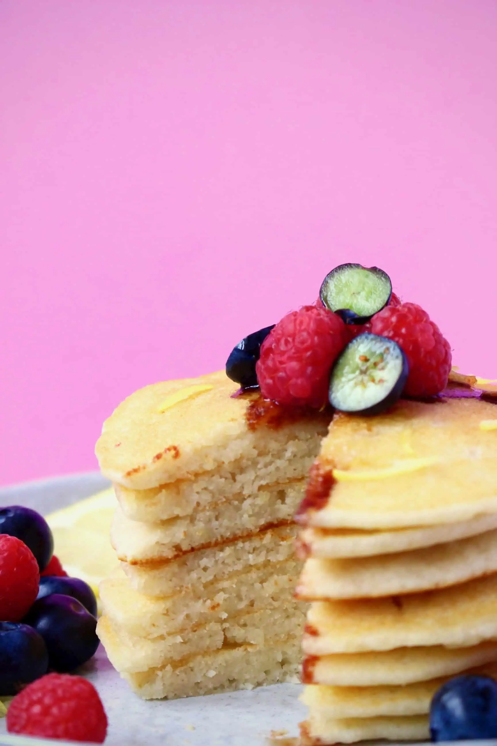 A stack of gluten-free vegan pancakes topped with fresh berries 