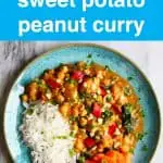 Chickpea and sweet potato curry and white rice on a blue plate against a marble background