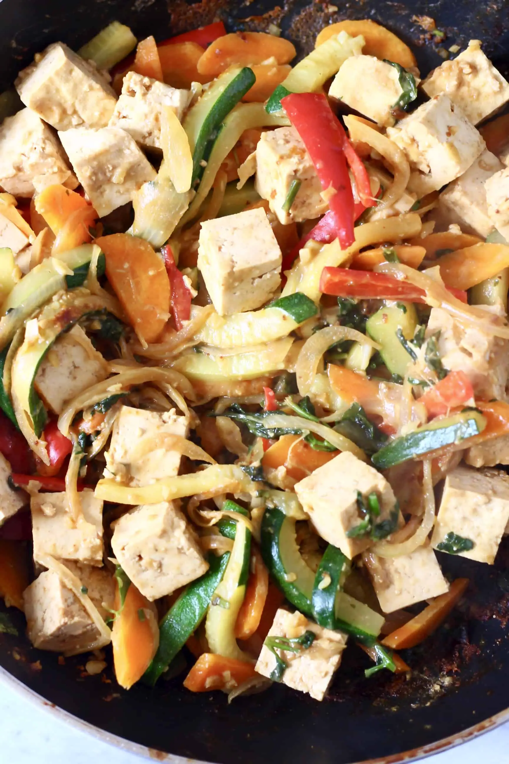 Chopped vegetables and tofu cubes in a frying pan