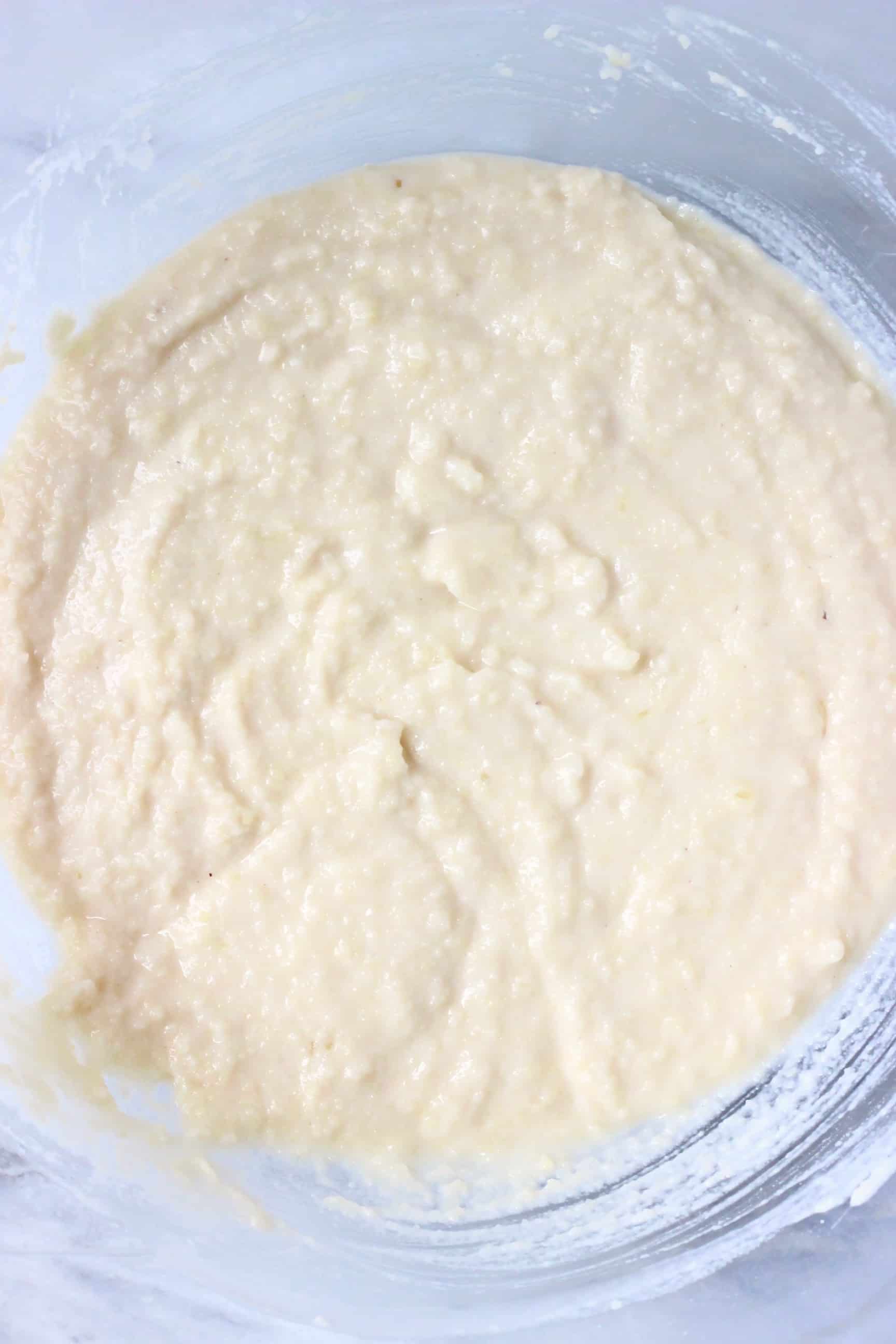 Raw gluten-free vegan madeleine batter in a glass mixing bowl