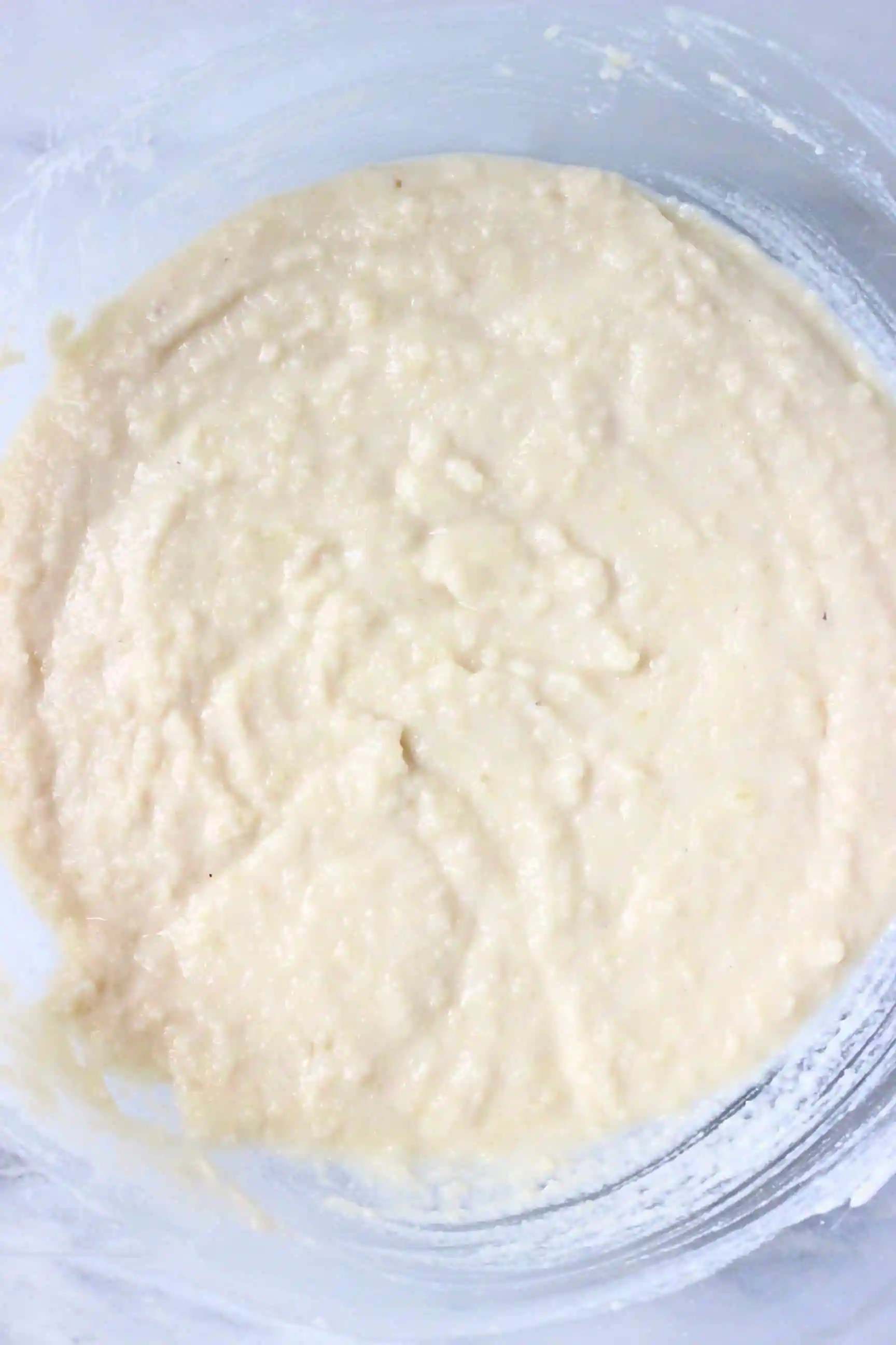 Raw gluten-free vegan madeleine batter in a glass mixing bowl