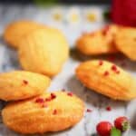 Seven gluten-free vegan madeleines on a marble background