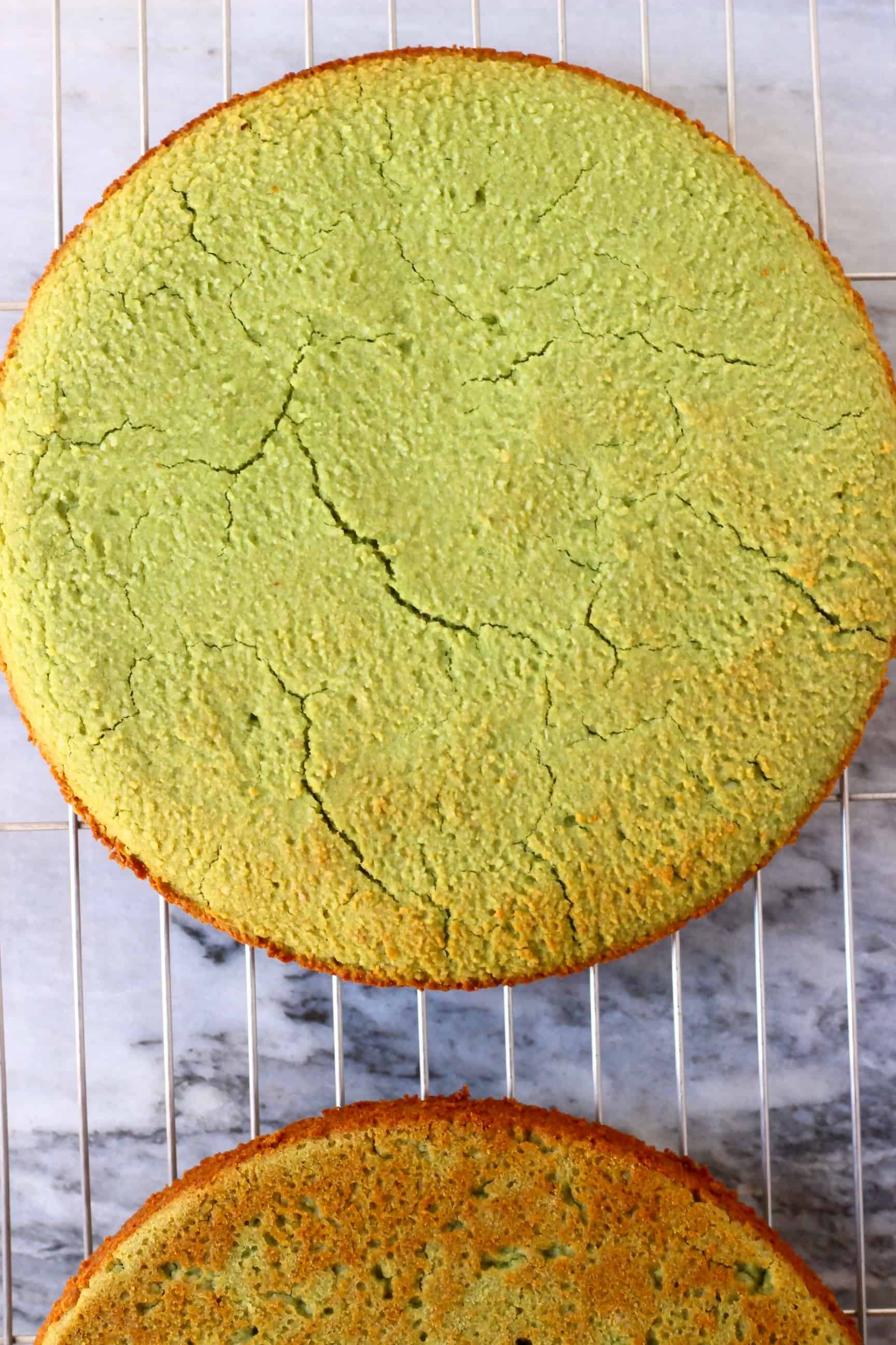 Two gluten-free vegan matcha cakes on a wire rack 