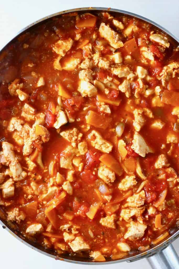 Photo of tofu crumbles and vegetables in a red tomato sauce