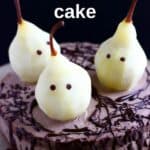 Photo of a chocolate cake topped with three pears made to look like ghosts