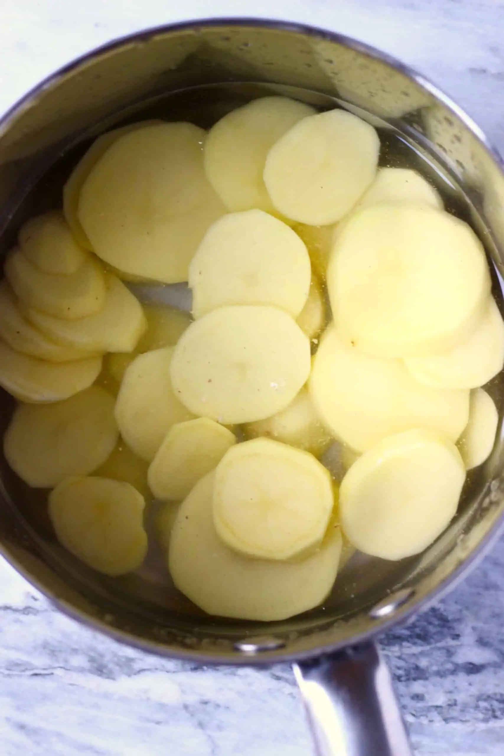 Sliced potatoes and water in a pan