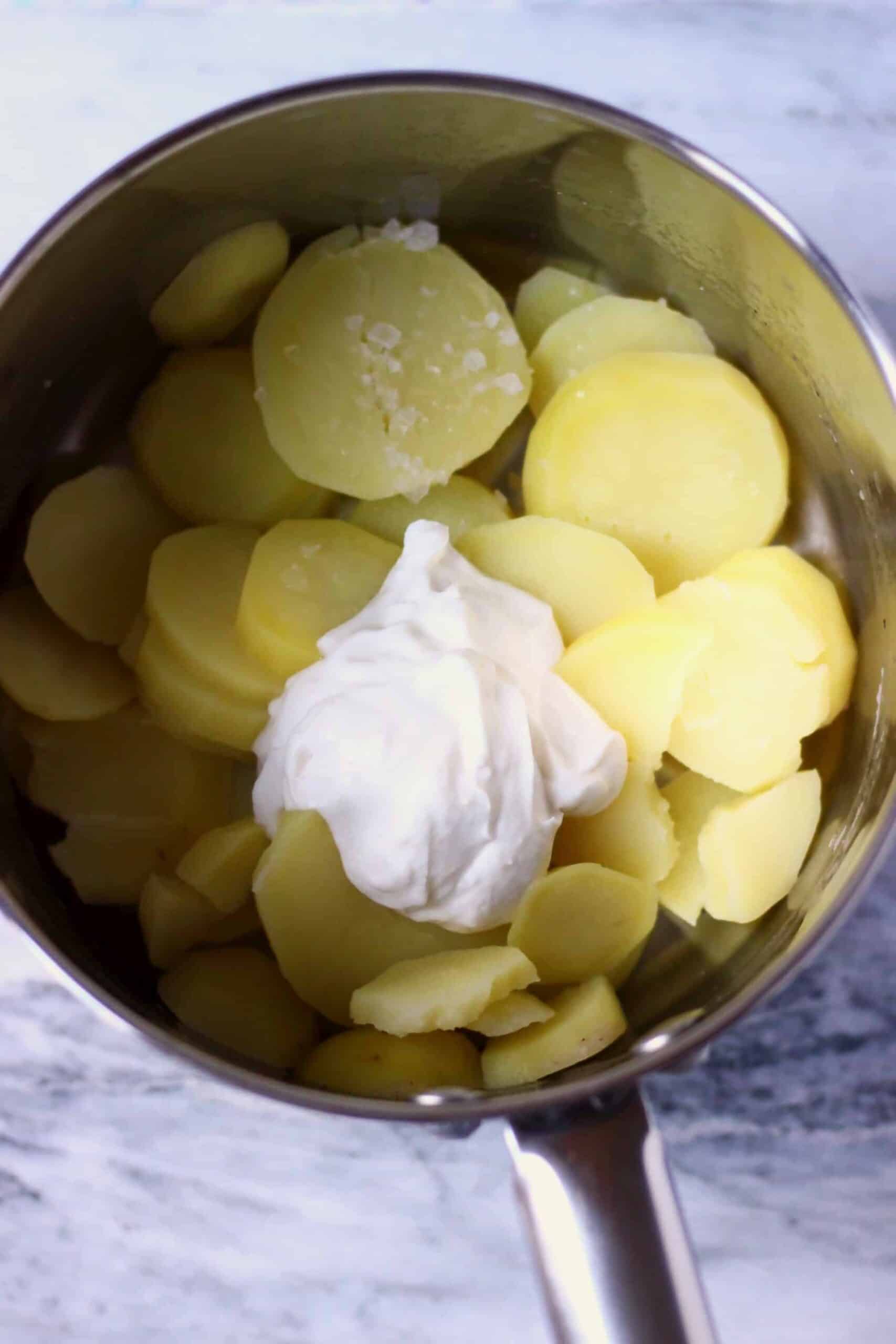 Cooked sliced potatoes and blended cashew cream in a pan