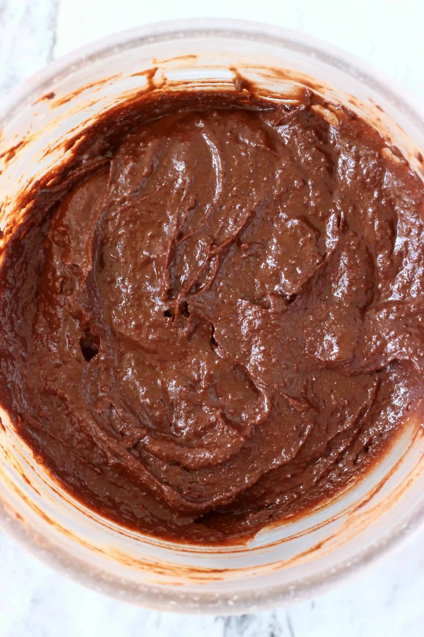 Raw gluten-free vegan chocolate mousse cake batter in a mixing bowl