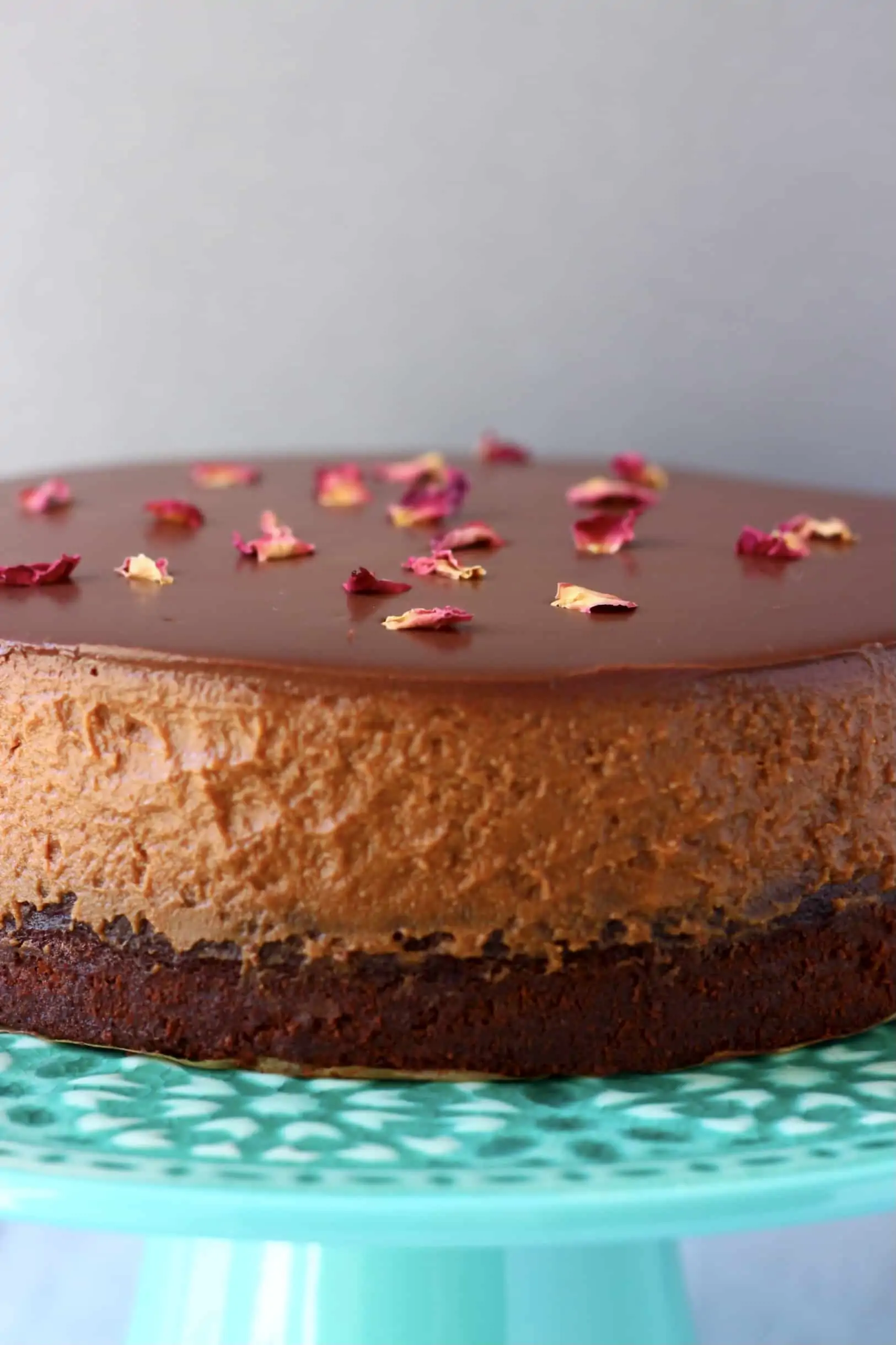 A gluten-free vegan chocolate mousse cake on a cake stand