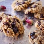 Gluten-free vegan oatmeal raisin cookies on a silver cake stand