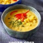 Two bowls of corn chowder against a grey background