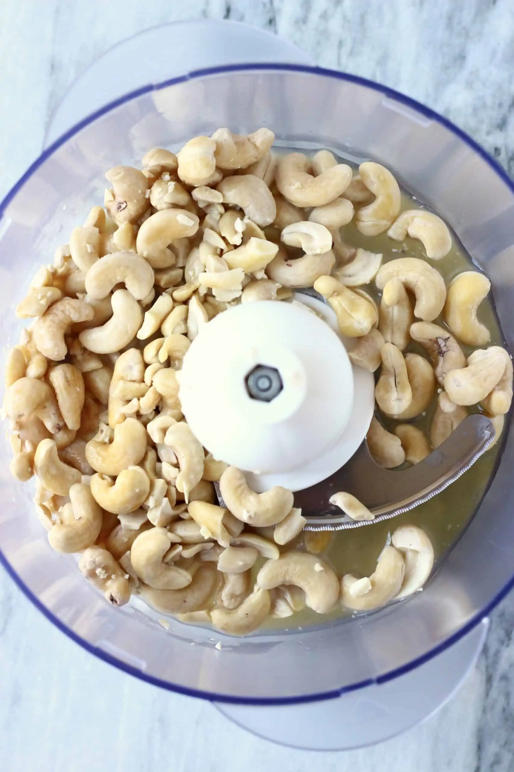 Cashew nuts, maple syrup and almond milk in a food processor