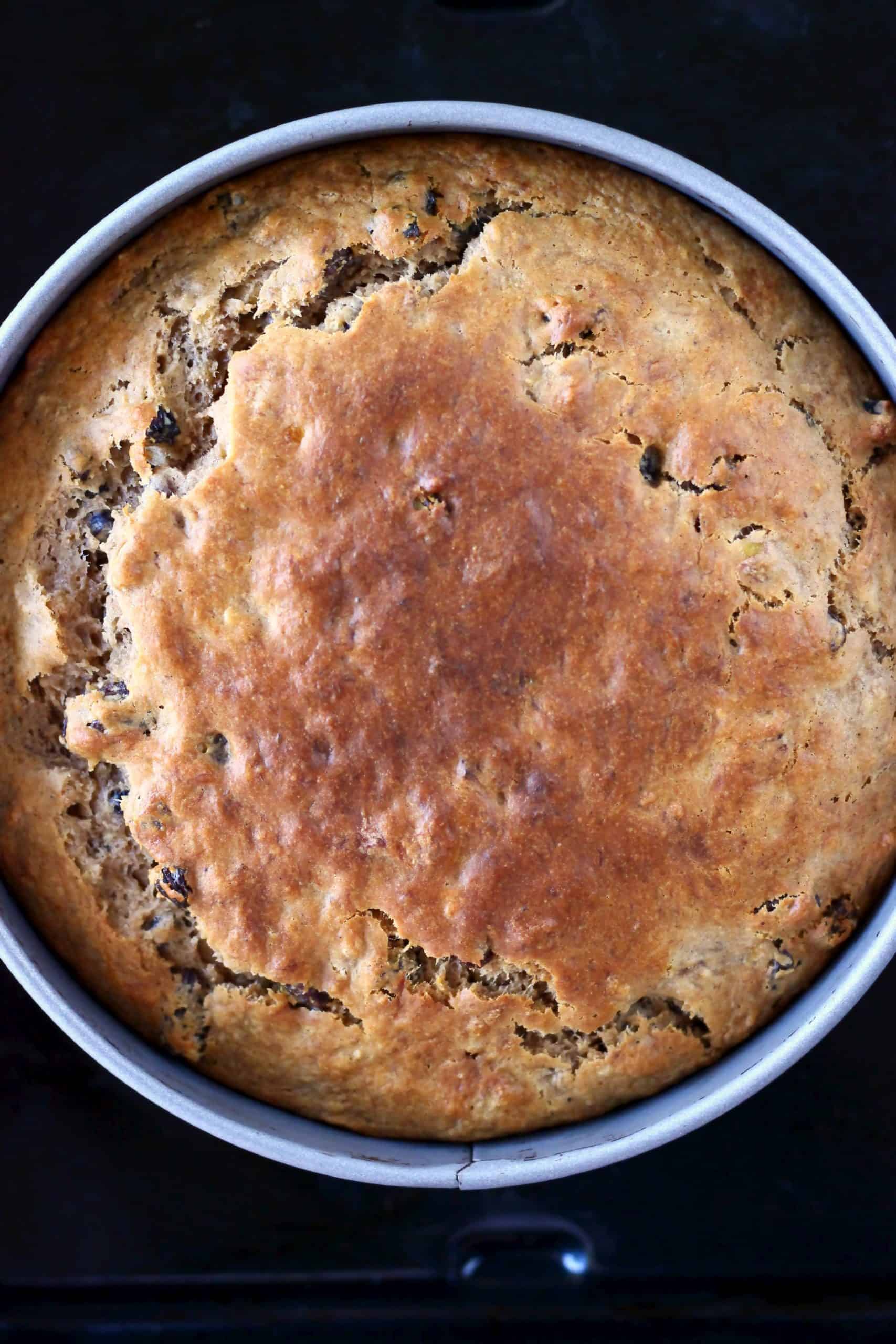Baked gluten-free vegan banana cake in a round baking tin