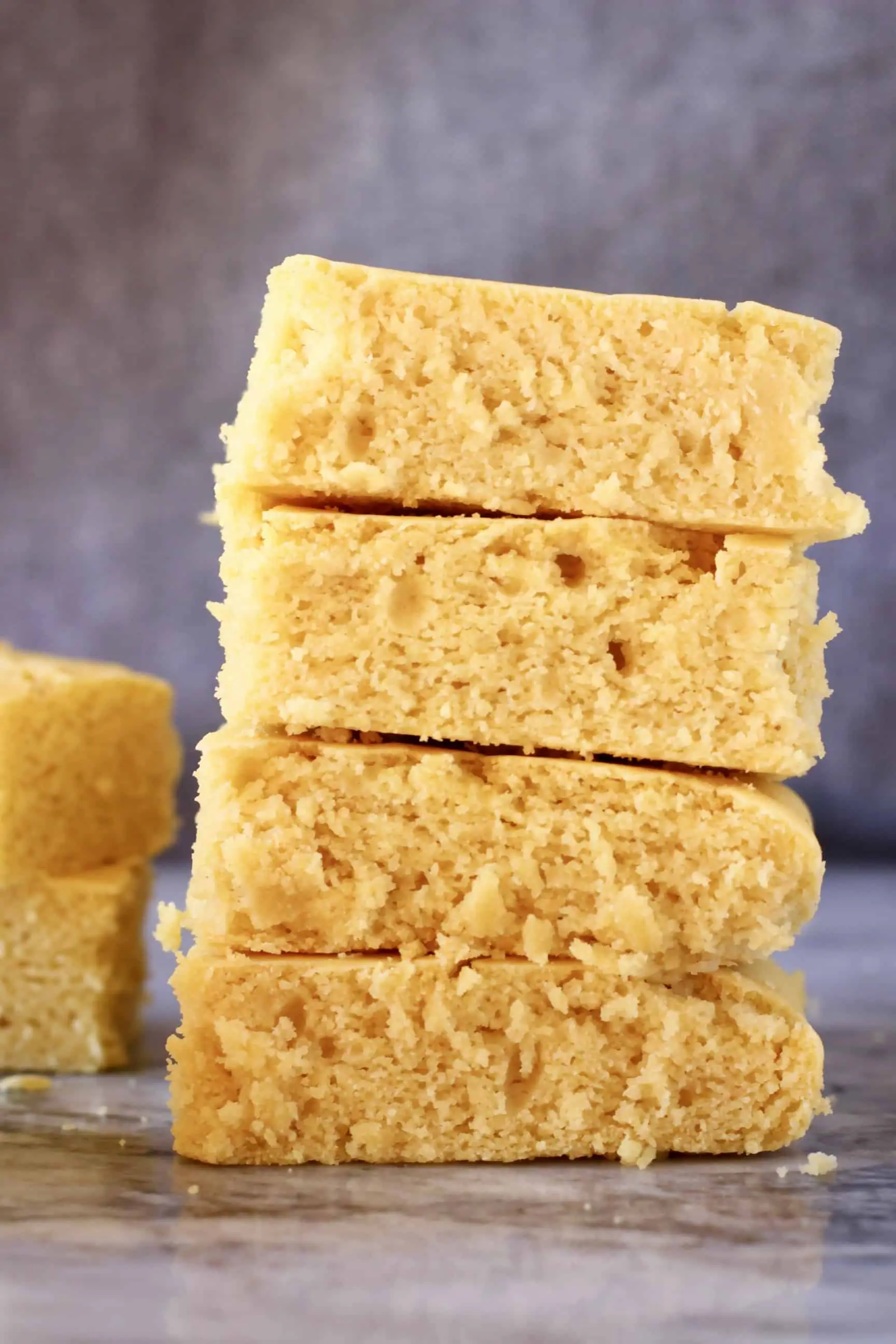 Four squares of gluten-free vegan cornbread stacked on top of each other 