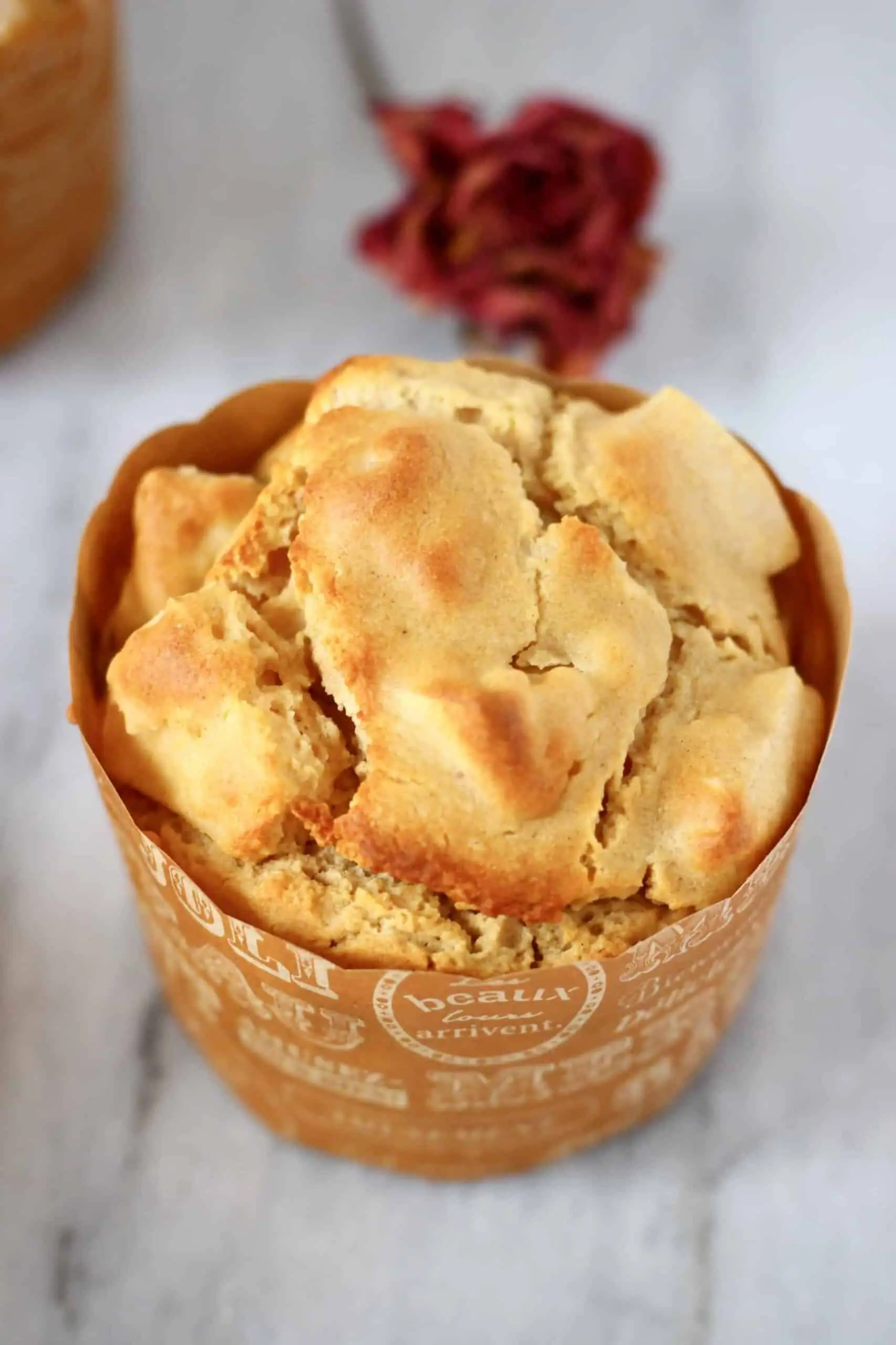 A gluten-free vegan apple muffin in a brown muffin case