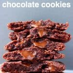 A stack of six chocolate cookies on a sheet of brown baking paper against a grey background