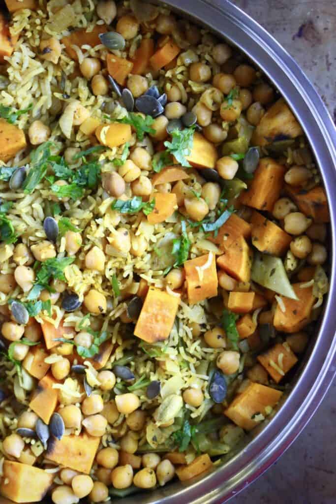 Yellow rice with pumpkin and chickpeas in a silver saucepan