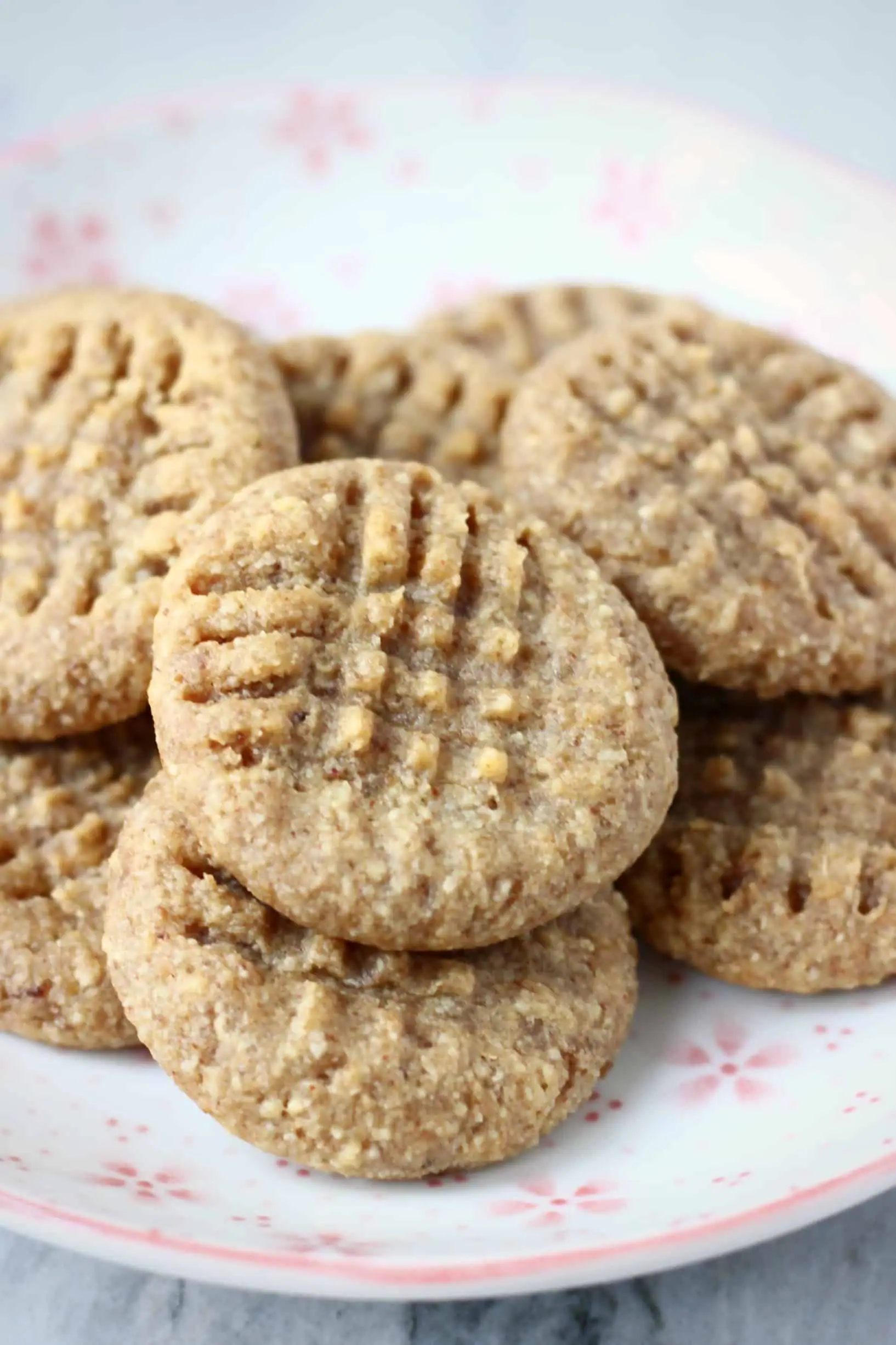A pile of gluten-free vegan peanut butter cookies on a plate