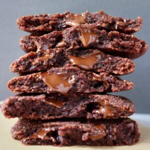 A stack of halved chocolate cookies against a grey background