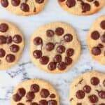 Six chocolate chip cookies against a marble background