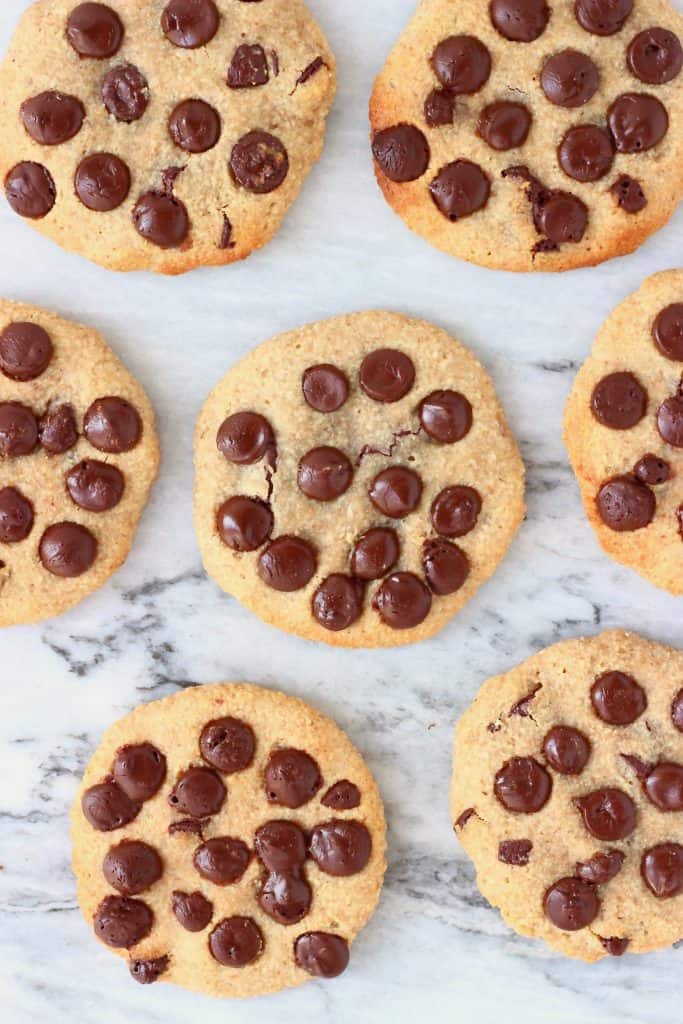 Six chocolate chip cookies against a marble background