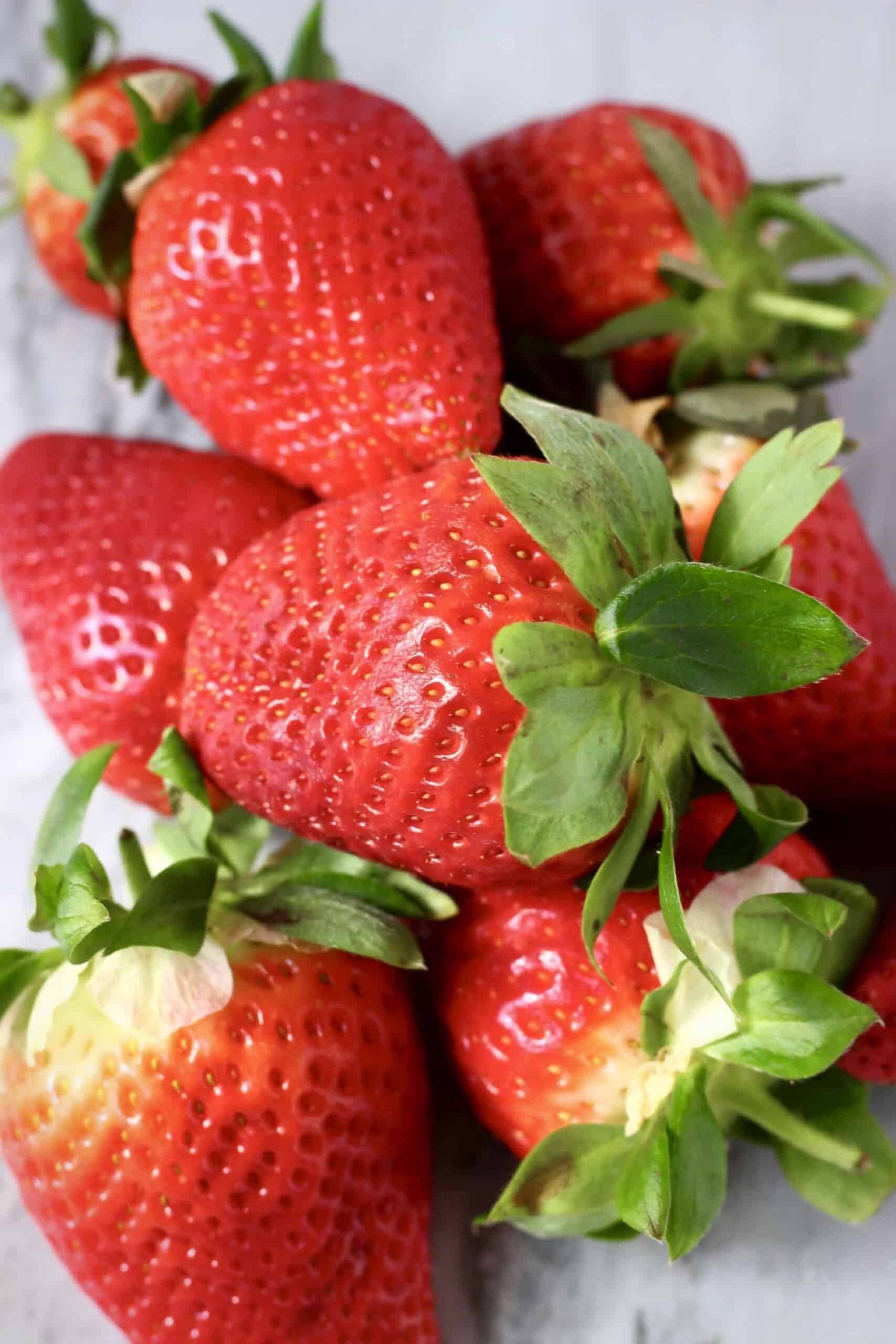 A pile of strawberries on a marble background