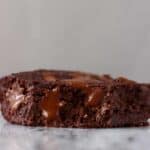 A vegan gluten-free chocolate brownie with a bite taken out of it