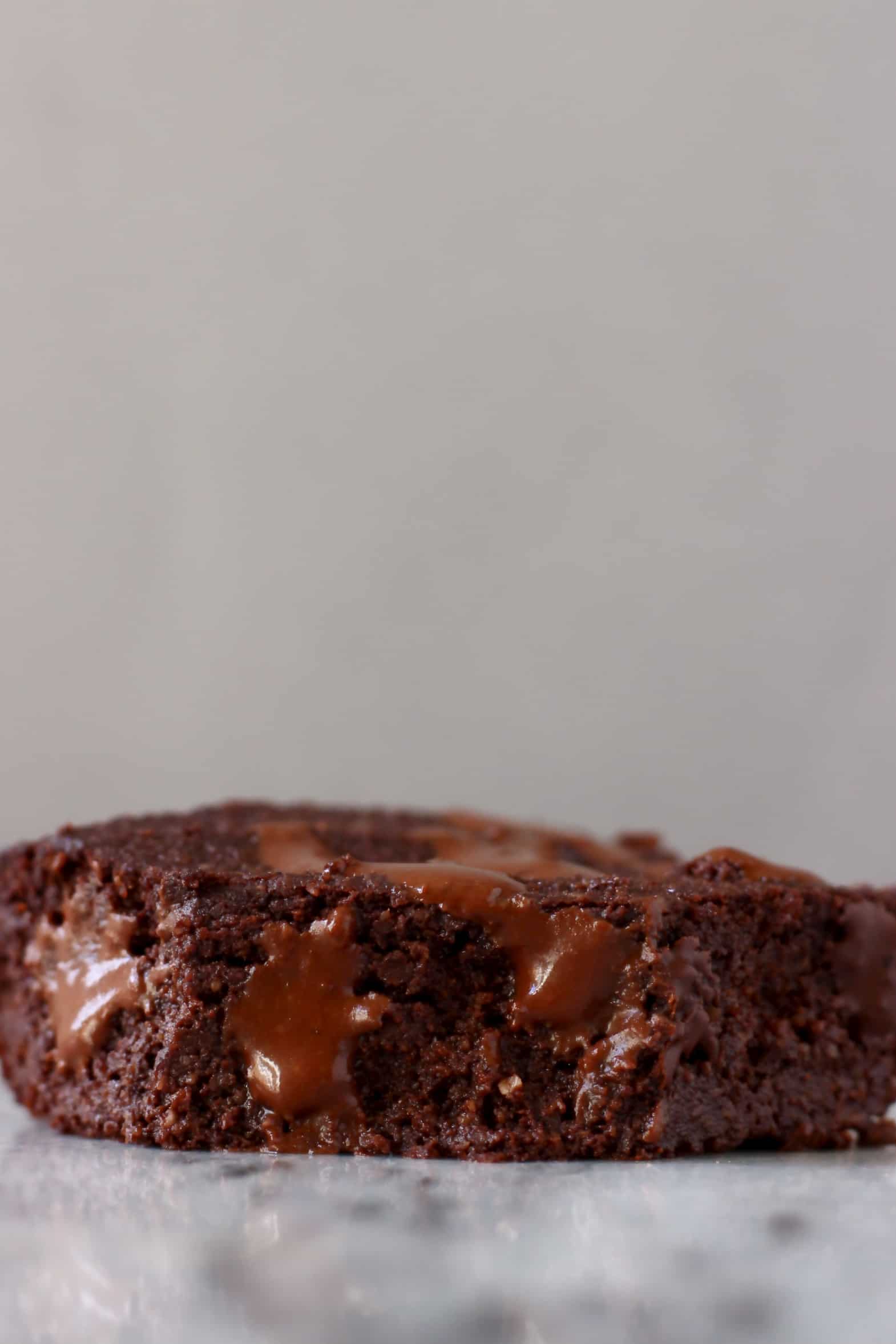 A vegan gluten-free chocolate brownie with a bite taken out of it