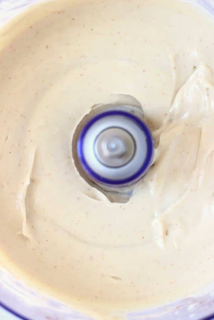 Photo of a light brown peanut butter pie filling in a food processor taken from above