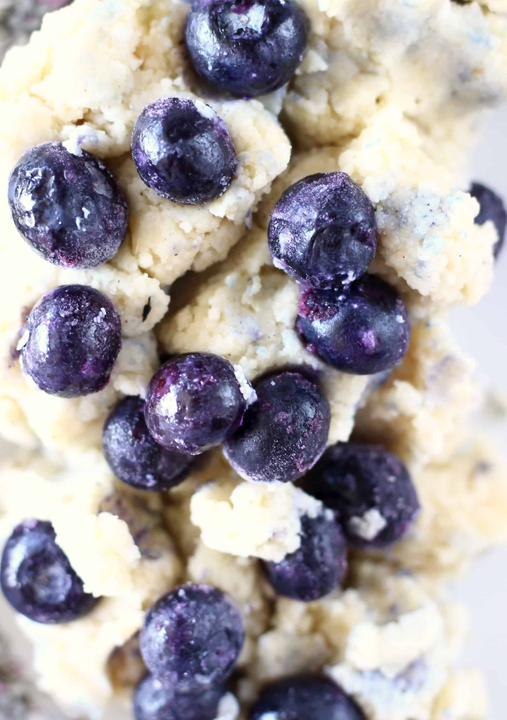 Raw gluten-free scones dough with blueberries in a mixing bowl