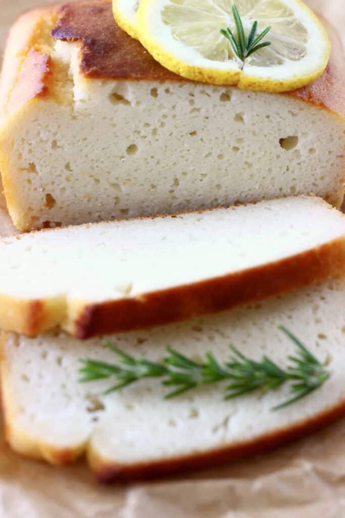Photo of a sliced white pound cake with two slices