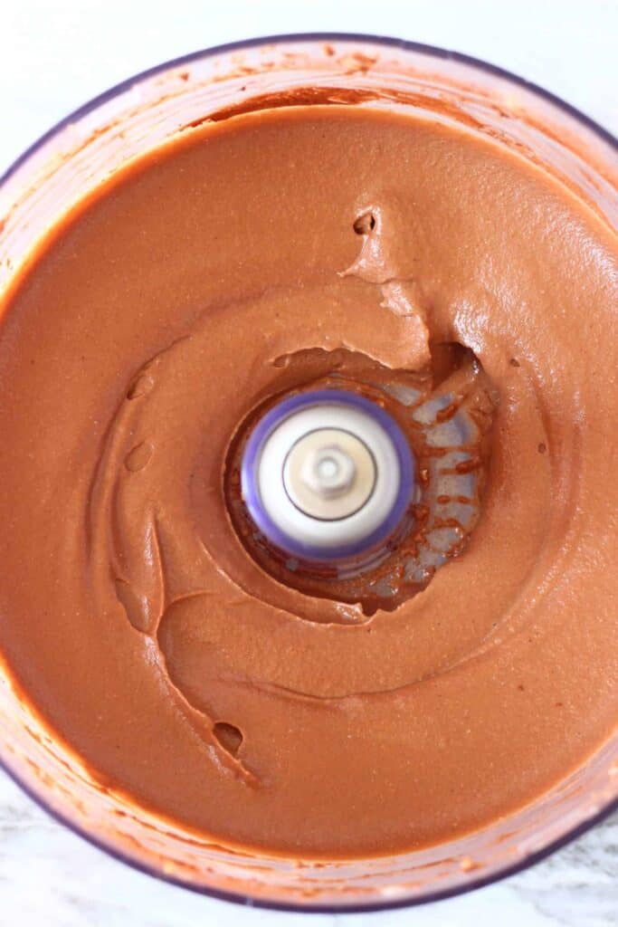 Photo of chocolate cheesecake filling in a food processor taken from above
