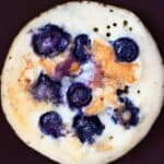 Photo of a blueberry pancake in a frying pan