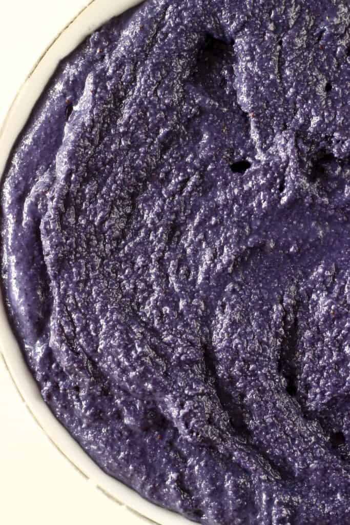 Photo of deep purple cake batter in a white bowl against a white background