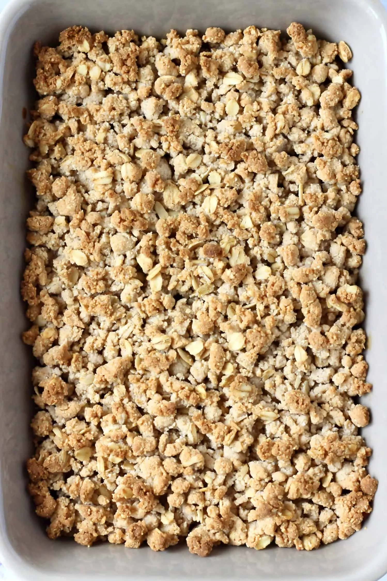 Golden brown gluten-free vegan apple crumble in a rectangular baking dish