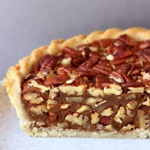 A sliced gluten-free vegan pecan pie on a plate