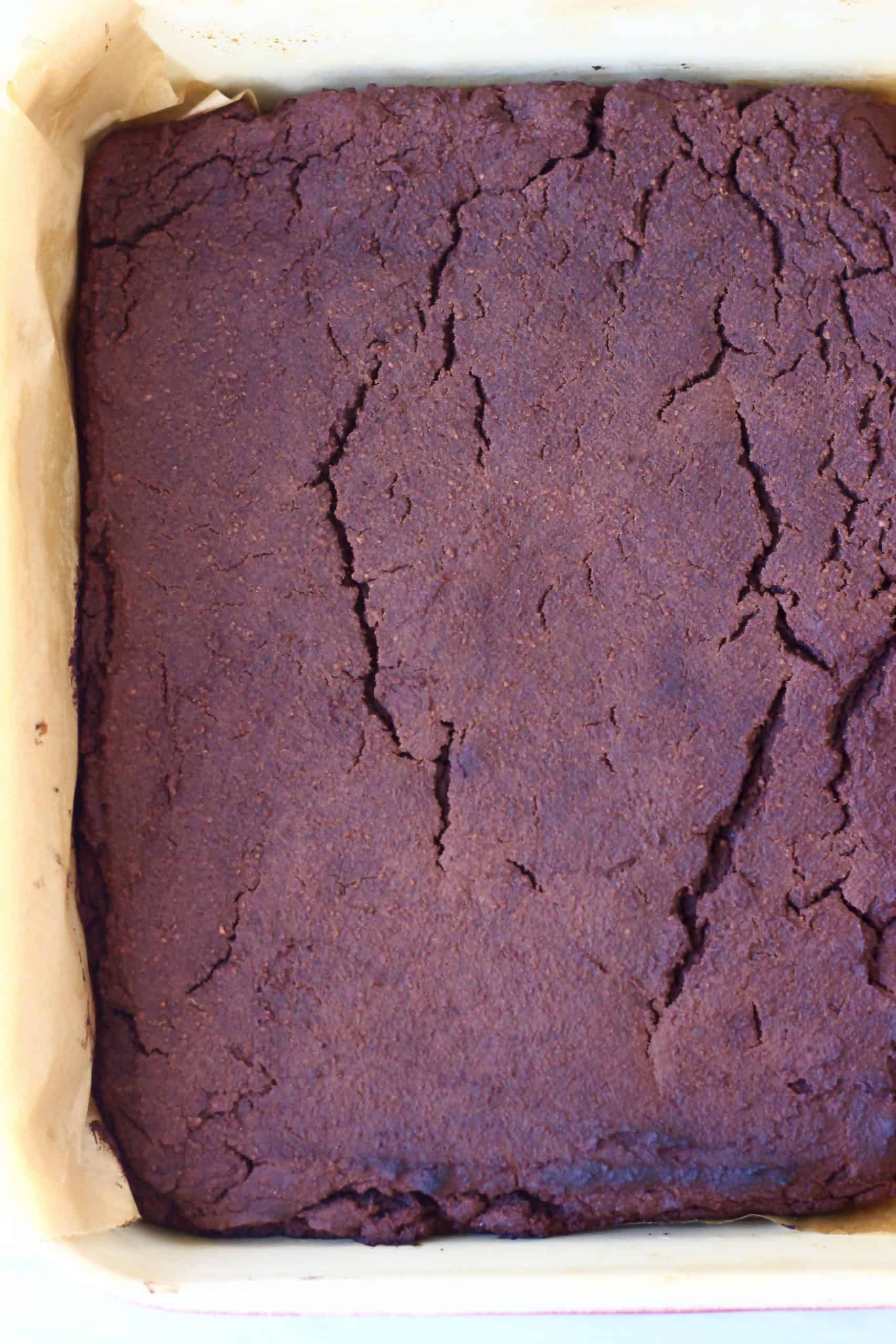 Vegan black bean brownies in a square baking tin lined with baking paper