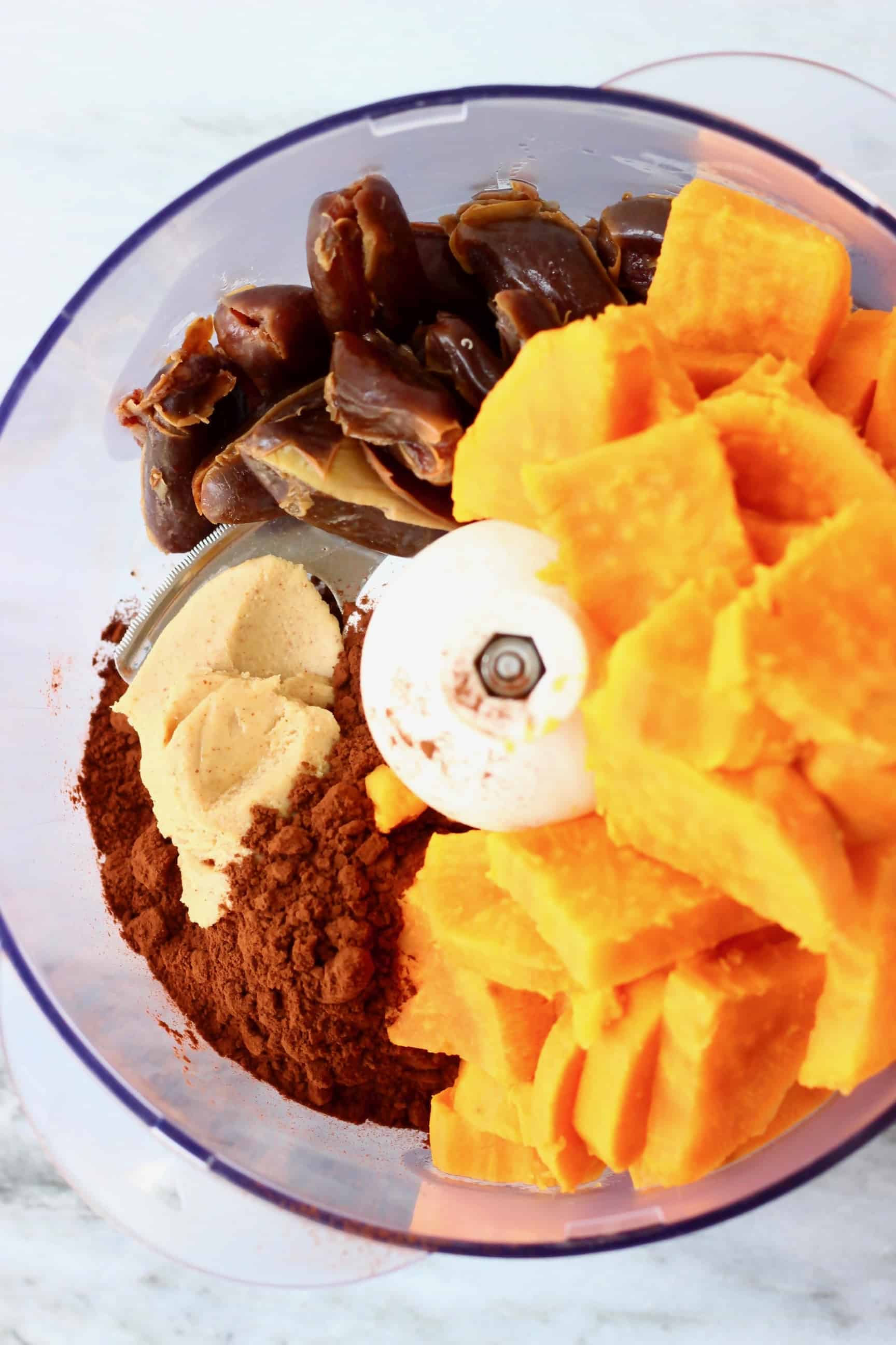 These Sweet Potato Brownies are seriously fudgy, rich and indulgent. They're made in just one bowl (food processor) and are vegan, dairy-free, egg-free, gluten-free, grain-free, refined sugar free, date-sweetened and oil-free. The best healthy dessert! #rhiansrecipes #vegan #brownies #sweetpotato #dessert #gluten-free #dairyfree #grainfree #oilfree Cooked sweet potato, dates, peanut butter and cocoa powder in a food processor