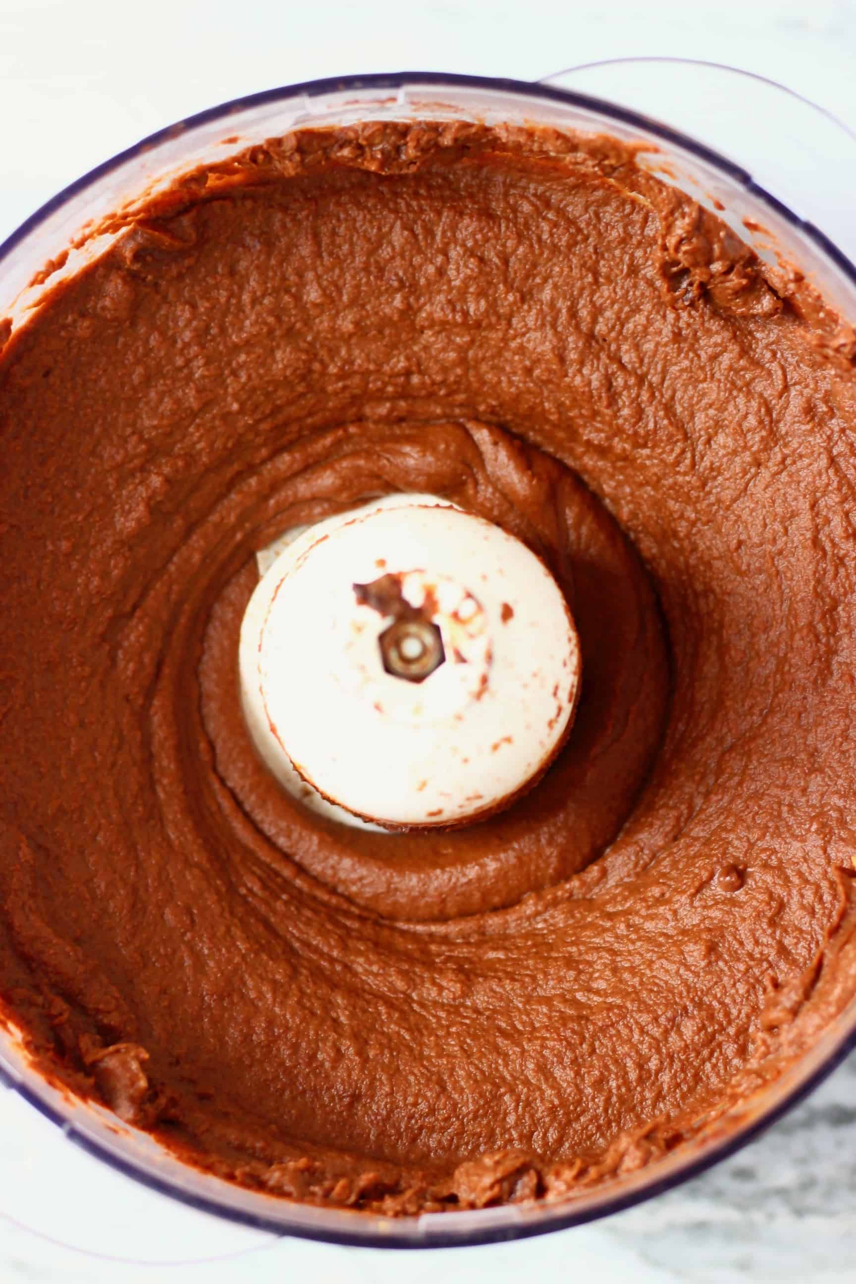 These Sweet Potato Brownies are seriously fudgy, rich and indulgent. They're made in just one bowl (food processor) and are vegan, dairy-free, egg-free, gluten-free, grain-free, refined sugar free, date-sweetened and oil-free. The best healthy dessert! #rhiansrecipes #vegan #brownies #sweetpotato #dessert #gluten-free #dairyfree #grainfree #oilfree Sweet potato brownie batter in a food processor