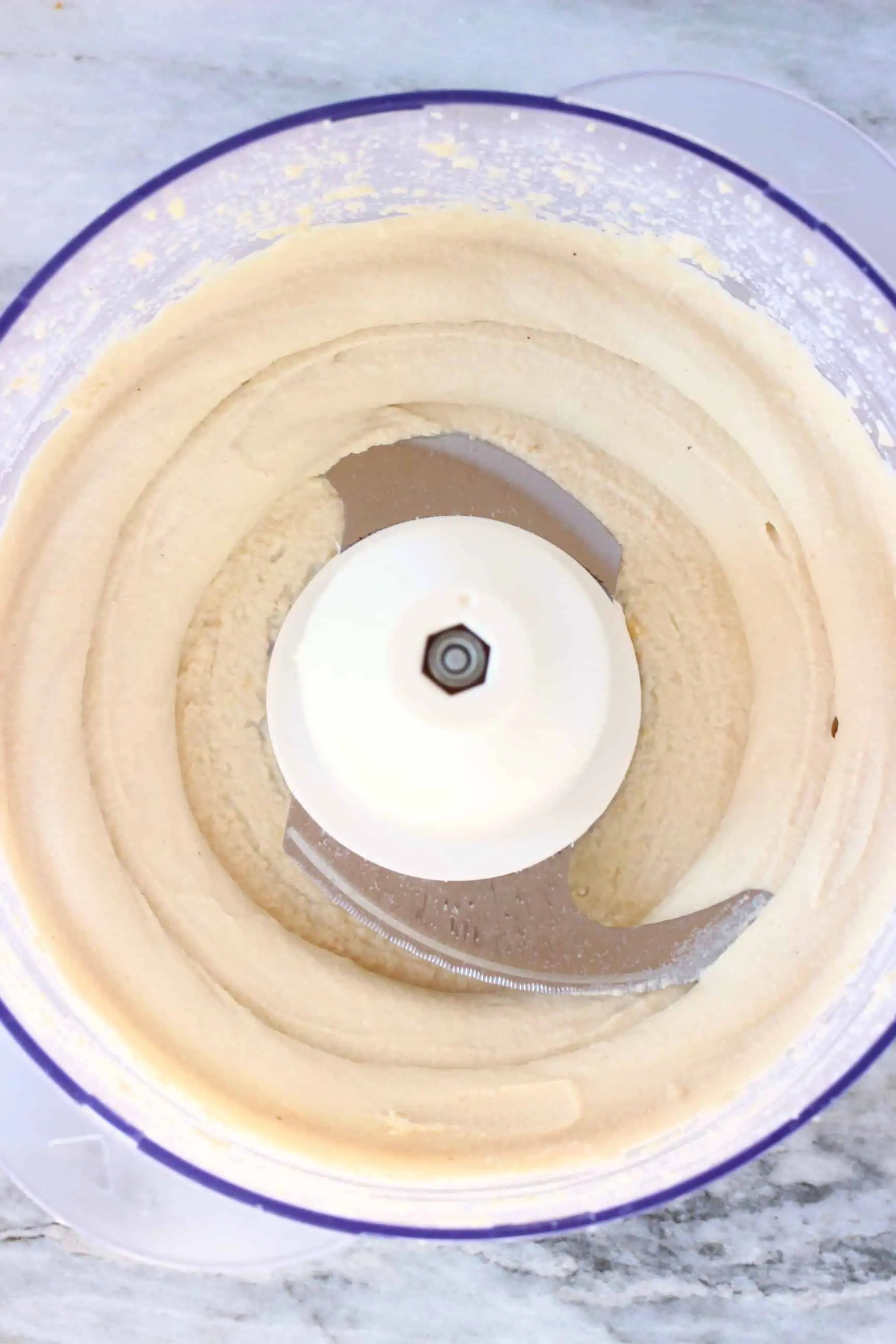 White vegan cashew buttercream frosting in a food processor